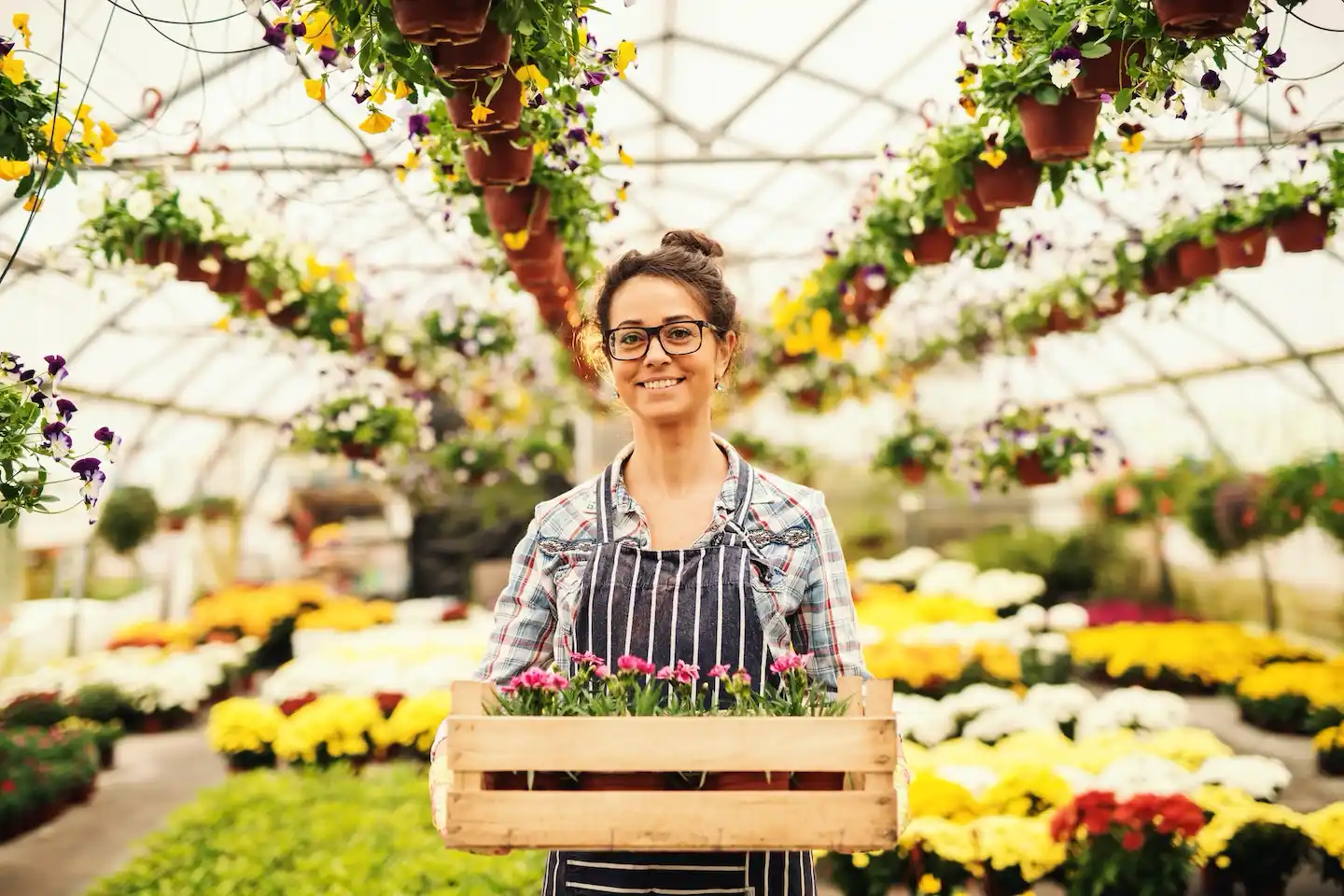 Female florist standing in nursery.