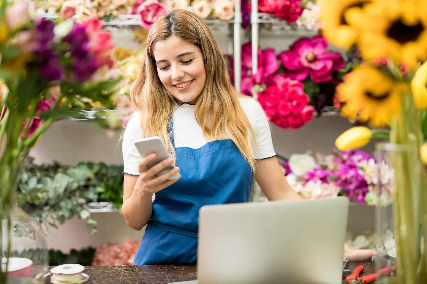 Female florist using phone.