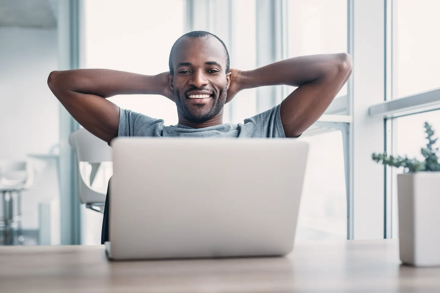 A man relaxing while using laptop.